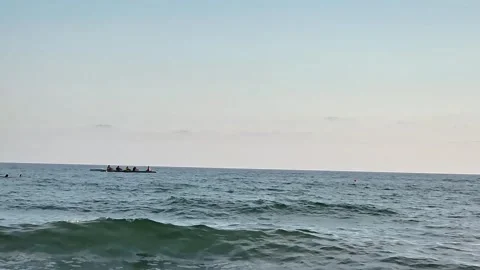 Calm Sea Waves Breaking on Sandy Shore with Distant Fishing Boat Stock Footage 340602734