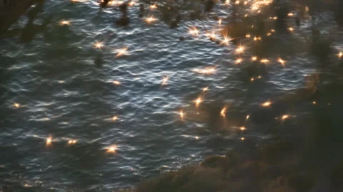 Calm sea waves creating a shimmering and sparkling water surface Stock Footage 331194977