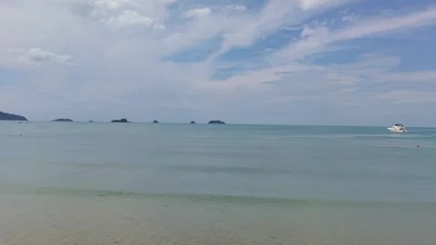 Calm sea waves gently rolling on sandy beach under cloudy sky Video stock 311750426