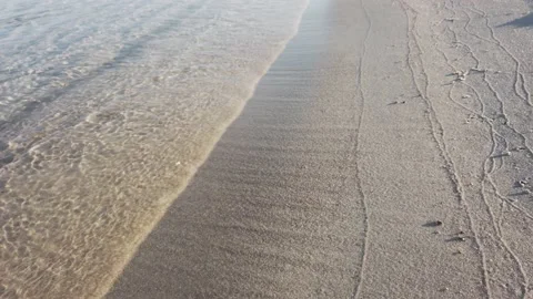 Calm sea waves mark lines on sandy beach Stock Footage 137448425