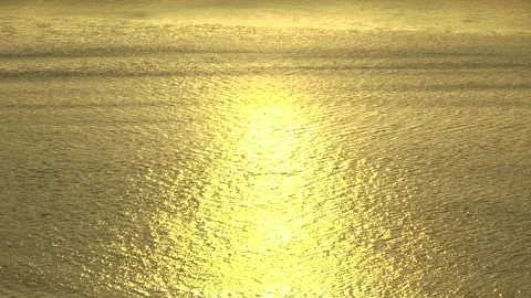 Calm sea waves sparkling in the light of the setting sun. Stock Footage 321138599