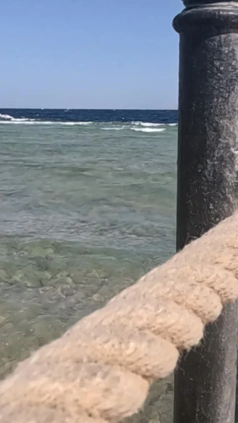 Calm Seascape: Captivating Views of Tranquil Waters and a Nautical Rope Detail Stock Footage 330095747