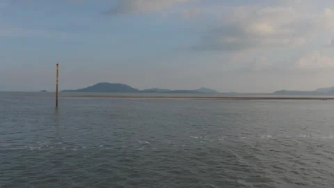 A calm seascape with gentle waves, distant hills Video stock 310787464