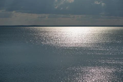 A calm seascape with the reflection of the sun on the surface of the water .. 写真素材