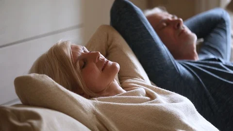 Calm senior middle aged couple relaxing leaning on comfortable couch Stock Footage 107065739