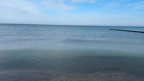 Calm shallow water at the beach with groins and blue sky. Stock Footage 309209088