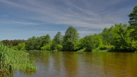 Calm, small river in spring time.  Stockbeeldmateriaal 76251419