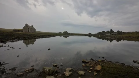 Calm still day with reflections over the water outside norhead on swona  Stock Footage 303847006