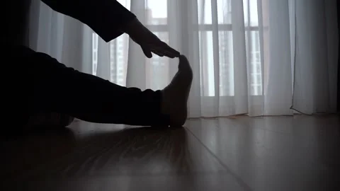 Calm stretching by the window in soft light Stock Footage 304774544