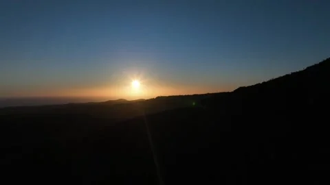 Calm Sunset with Deep Blue Sky and Mountain Silhouette – Gran Canaria Aerial Stock Footage 309943620