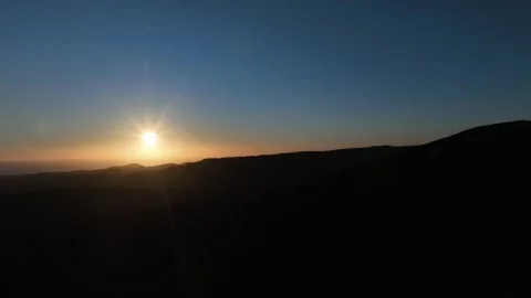 Calm Sunset Over Endless Mountain Ridge with Deep Blue Sky – drone Stock Footage 309943616