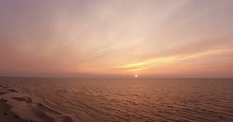Calm sunset over the  sea with red sky and clouds was filmed with drone Stock Footage 71461680