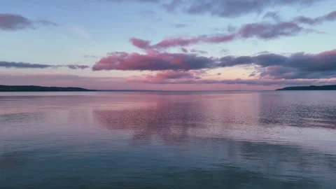 Calm Sunset Reflection on Lake Water Surface with Pink Clouds Video stock 331710891