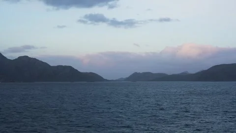 Calm Sunset Strait of Magellan Blue Ocean and Colorful Clouds Stock Footage 277920147