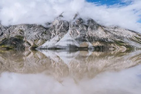 The calm surface of the lake and the reflection of the mountains by the lake Stock Photos