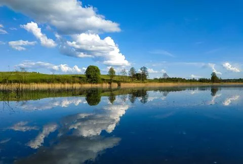 Calm surface of the lake like a mirror Stock Photos
