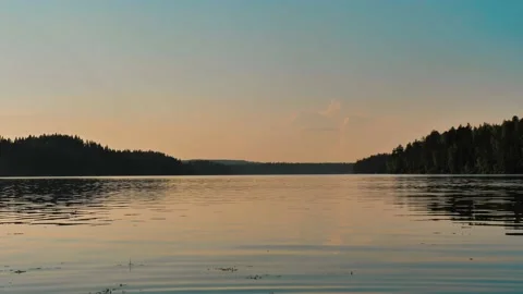 Calm surface of the lake with reflections of sunset soft lights on it. Beautiful Stock-Footage 202650614