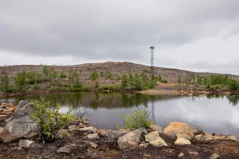 The calm surface of a small lake surrounded by the rocks on the north of Russ Stock Photos