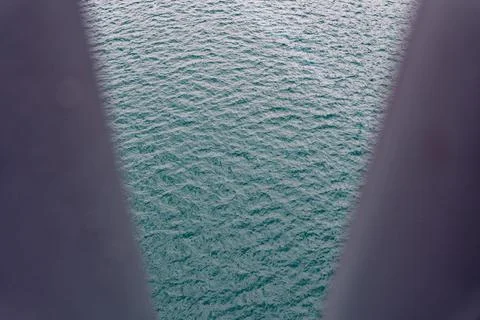 Calm Teal Ocean Surface Framed by Blurred Bridge Pillars at Nanfangao Taiwan Stock-Fotos