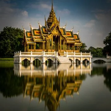 Calm temple in Ayutthaya, Thailand with long exposure reflection in lake Stock Photos