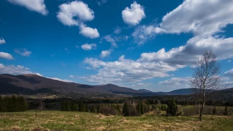 Calm timelapse with moving clouds over a mountainous area on a sunny day. Stock Footage 301522797