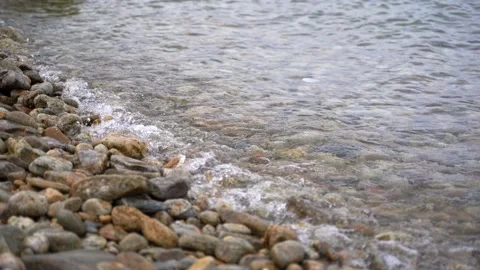 Calm tranquil waves lapping on a pebble shore on Lake Baikal. Stock Footage 132100790