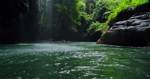 Calm Tropical River Flow Through Canyon Forest for Relaxation  Background 動画素材 332415403