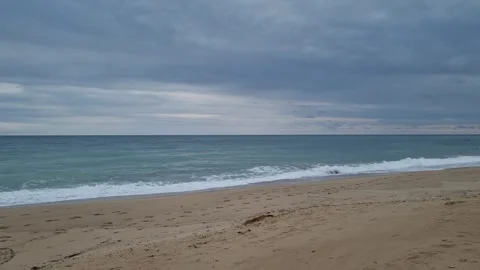 Calm turquoise sea waves rolling on sandy beach in Varna Stock Footage 320134196