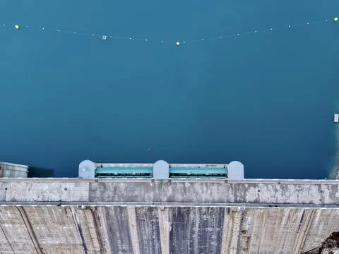 Calm turquoise waters with markers, Drones capture peaceful dam scene with .. Stock Photos