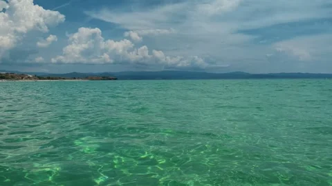 Calm turquoise waters stretch to distant shores. Trani Ammouda, Greece Stock Footage 339618566