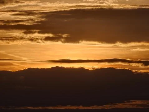 Calm twilight view featuring multihued clouds and peaceful horizon silhouet.. Фото