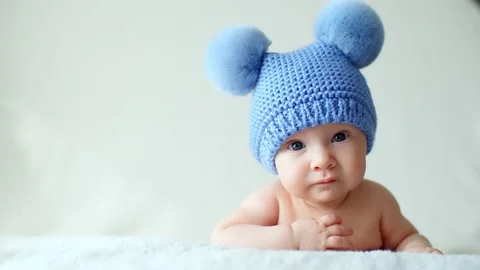 Calm two-month-old infant is lying on a blanket. Beautiful, cute little child Stock Footage 163599535