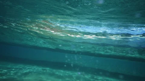 Calm Underwater View of Ocean Surface With Breaking Wave in Clear Water Stock Footage 326097495