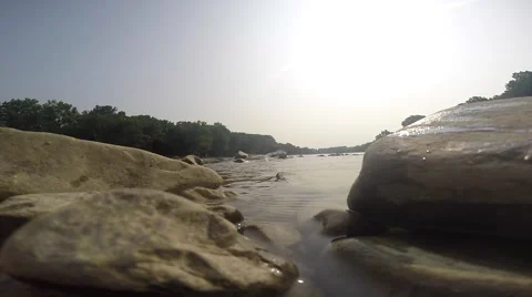 Calm water flowing between large rocks in peaceful river. Video stock 40650130