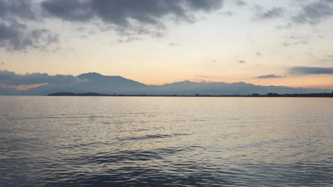 Calm water reflecting changing sky at sunset in Lake Garda, Italy Stock Footage 287821243