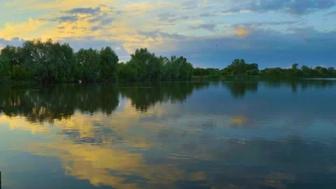 Calm Water Reflection of Sunset Sky and Trees Stock Footage 326377502