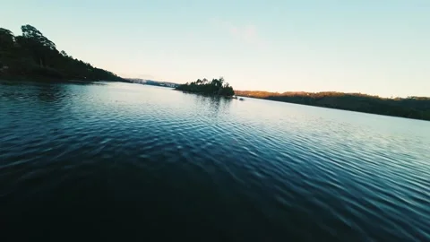 Calm water ripples gently under soft twilight sky at Castelo de Bode Stock Footage 342265433