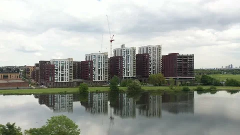 Calm water surface mirroring modern housing estate buildings Video stock 155791745