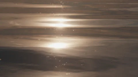 Calm water surface with reflection of the sun and summer clouds Stock Footage 338039455