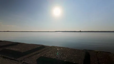 Calm Water Surface Under Bright Sun Minimal Nature Background 4K Video stock 327274285