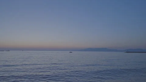 Calm water surface with waves lit by setting sun light Video stock 258466333