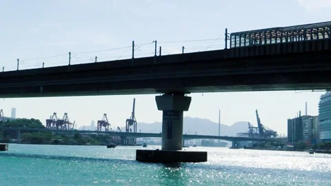 Calm waters reflect the bridge with cranes in the harbor Stock Footage 323785519