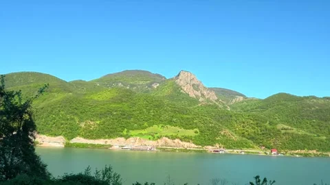 Calm waters reflect a clear blue sky. Balkan, Eastern Europe, POV Video stock 333349819