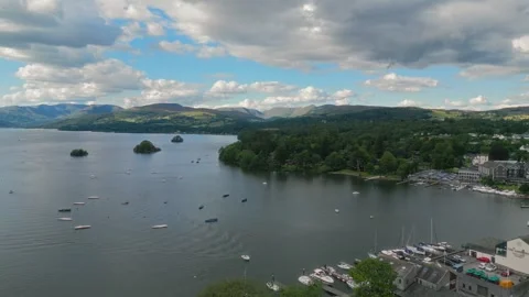 Calm waters reflect distant hills under soft clouds Stock Footage 345521865