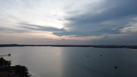 Calm waters reflect the dynamic sky nearby Stock Footage 325193664