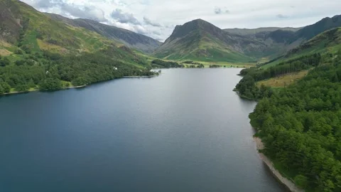 Calm waters reflect mountain peaks above Stock Footage 345523428