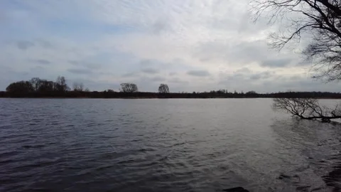 Calm waters at a river during cloudy afternoon in nature Vídeos de archivo 333440208