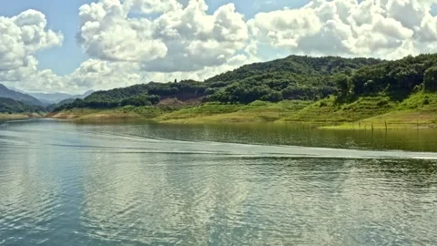 Calm waters, small boat under tall elevated bridge Stock Footage 160885560