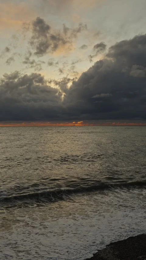 Calm waters under warm sky with soft golden hues and gentle surf 動画素材 335950616
