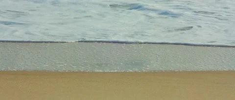 Calm wave foam on the shore of the beach, steady shot Stock Footage 212460932